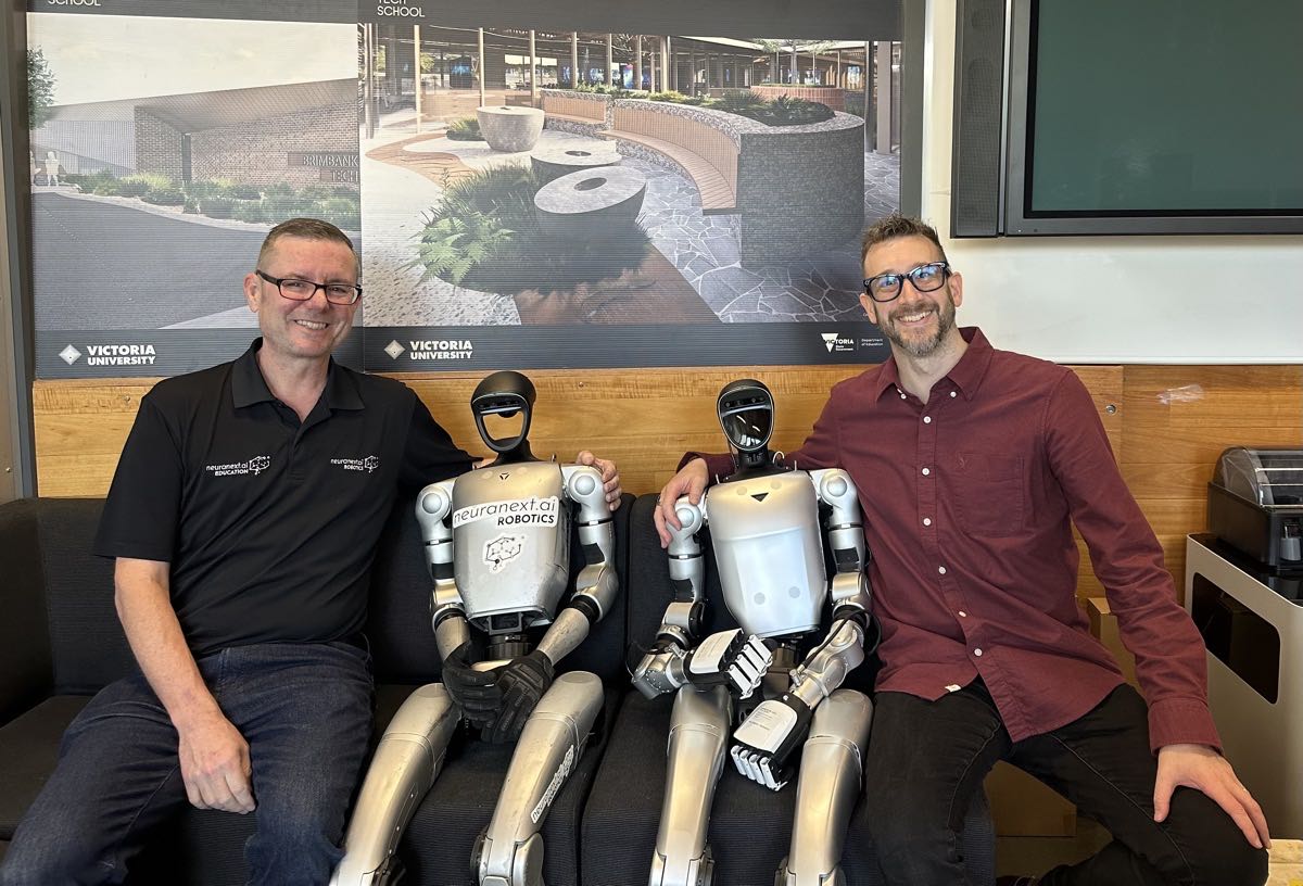 Adrian Tyson with humanoid robots at Brimbank Tech School